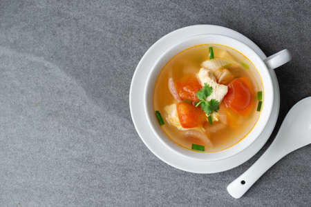 Hot soup chicken healthy at morning on concrete table.