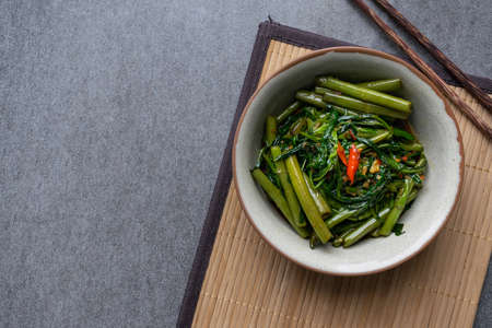 Fried morning glory in gray bowl on table.の写真素材