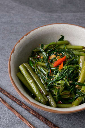 Fried morning glory in gray bowl on table.の写真素材