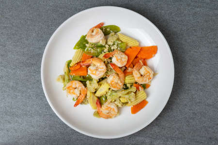 Fried vegetables with shrimp in oyster sauce for healthy in white dish on concrete table.の写真素材