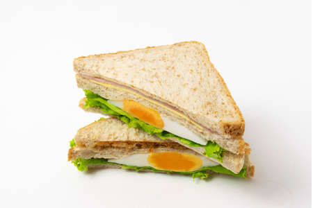 Homemade sandwich or toast wheat bread with lettuce and ham isolate on white background.の写真素材