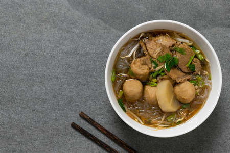 Vermicelli with beef in white bowl on concrete table.の写真素材