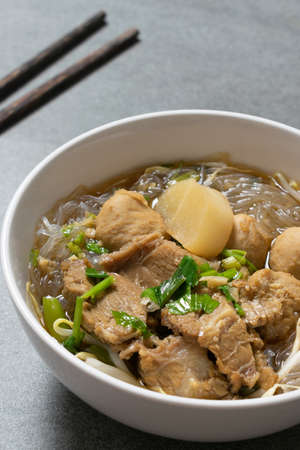 Vermicelli with beef in white bowl on concrete table.の写真素材
