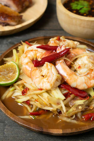 Papaya salad with pickled fish soup and shrimp in wooden table on wooden table.の写真素材