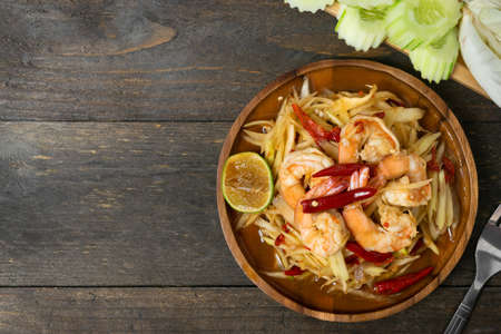 Papaya salad with pickled fish soup and shrimp in wooden table on wooden table.の写真素材