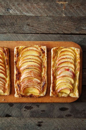 Delicious apple puff on a wooden tableの写真素材