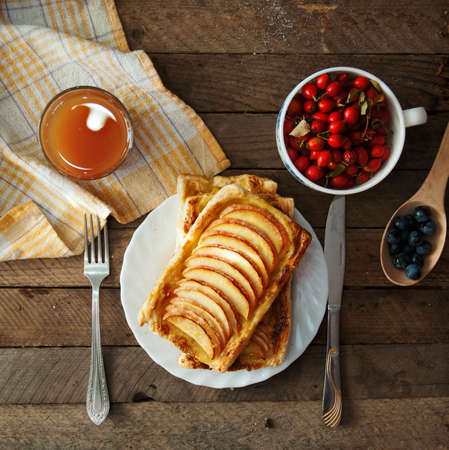 Delicious apple puff on a wooden tableの写真素材