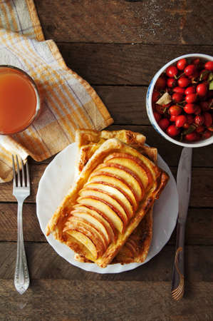 Delicious apple puff on a wooden tableの写真素材