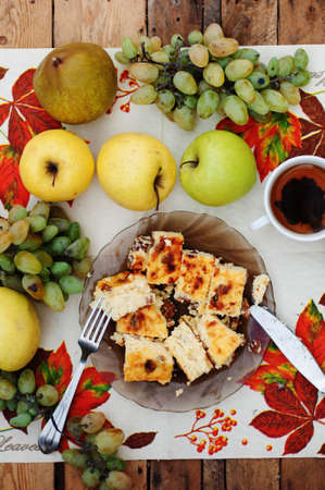 cheese casserole in the dish with green grapes on a wooden backgroundの写真素材