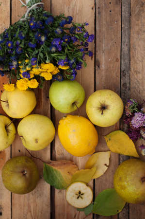 fruit, apples, pears, lemon on a wooden backgroundの写真素材