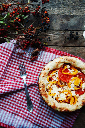 Delicious tomato pizza served on wooden tableの写真素材