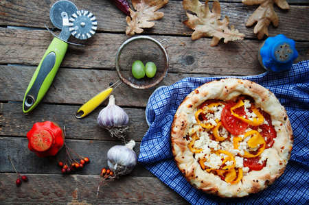 Delicious tomato pizza served on wooden tableの写真素材