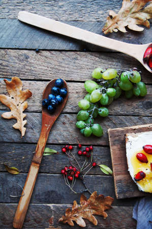 Sweet bread with red berry, honey and butter, butter and blueberry jam. Tasty bread with jam. Sweet sandwich, food, breakfast, morning, berry, fruit. Top view. Autumn harvest. Sandwiches. Grapesの写真素材