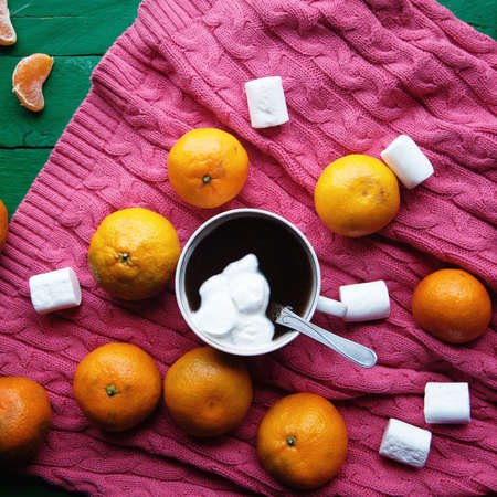 Winter decoration. Composition on wood background. Hot tea, candles, cut grapefruit. Christmas. Christmas mood. Christmas spirit. Fir branches. Tangerine slices. Conesの写真素材