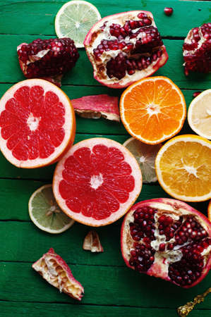 Fruit in a cut closeup, grapefruit, orange, lemon, tangerine, fruit background. rustic food. fruit. Fresh fruits.Mixed fruits background.Healthy eating, dieting, love fruits.の写真素材