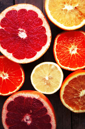 Fruit in a cut closeup, grapefruit, orange, lemon, tangerine, fruit background. rustic food. fruit. Fresh fruits.Mixed fruits background.Healthy eating, dieting, love fruits.の写真素材