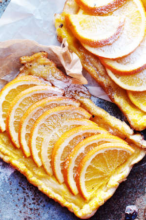 Homemade organic ruddy pies with apples puff pastry, ready to eat. Delicious apple puff on a wooden table, on a rustic wood kitchen table. Apple puff on breakfast, blueberries, food, pie.の写真素材