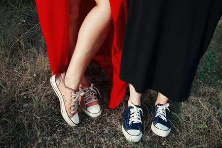 Pink and purple sneakers on grass background, filtered image.の写真素材