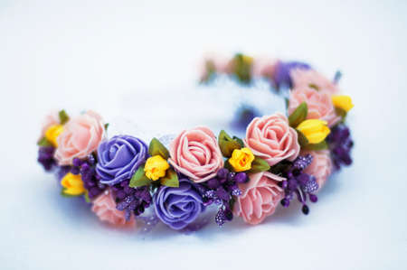 Hoop from flowers, wreath with colored flowers. Handmade flowers wreath on white. Accessory. Artificial flowers. Hair accessories. Beauty. Fashion. Decoration for the head. Wreath hair.の写真素材