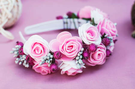 Hoop from flowers, wreath with colored flowers. Handmade flowers wreath on white. Accessory. Artificial flowers. Hair accessories. Beauty. Fashion. Decoration for the head. Wreath hair.の写真素材