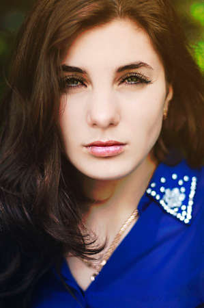 Portrait of a beautiful young girl outdoors. Outdoors portrait of beautiful young brunette woman...