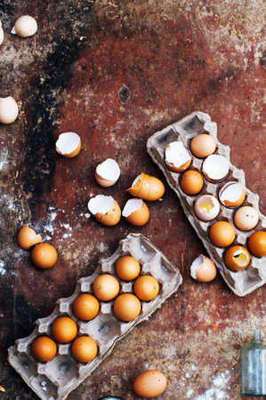 Baking cake ingredients - bowl, flour, eggs, egg whites foam, eggbeate on wood chalkboard from above.の写真素材
