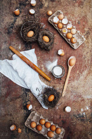 Baking cake ingredients - bowl, flour, eggs, egg whites foam, eggbeate on wood chalkboard from above.の写真素材