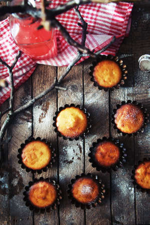 Homemade cupcakes onto an wooden background. Rustic style.の写真素材
