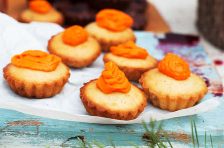 Homemade  cupcakes onto an wooden background. Rustic style. Homemade fresh pastries. Food background. Basic Vanilla cupcakes.の写真素材