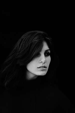 Portrait of exquisite beautiful young girl in a red blouse. Beautiful  portrait of a girl. Emotional portrait of Fashion stylish portrait of pretty young. Black and white photo.の写真素材