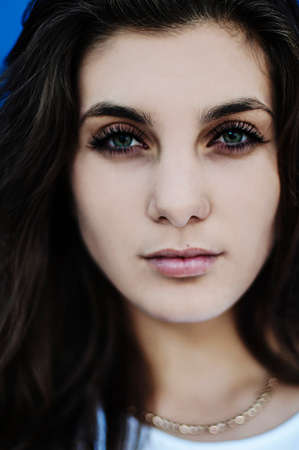 Portrait of a beautiful young girl outdoors. Outdoors portrait of beautiful young brunette woman looking at camera.の写真素材