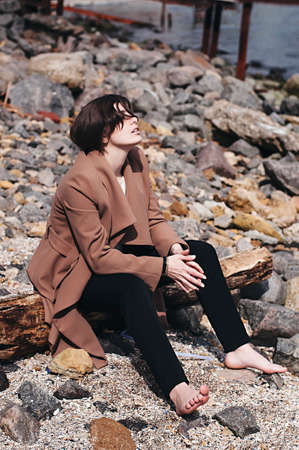 Fashion portrait of a girl on the sea. Portrait of girl on the sea background. Closeup sensual portrait of beautiful girl outdoors.の写真素材