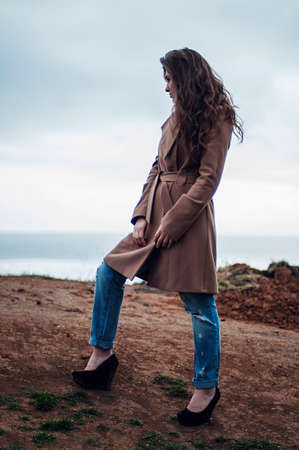 Fashion portrait of a girl on the sea. Portrait of girl on the sea background. Closeup sensual portrait of beautiful girl outdoors.の写真素材