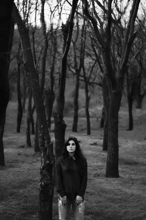 Portrait of a beautiful young girl outdoors. Outdoors portrait of beautiful young brunette woman looking at camera.の写真素材