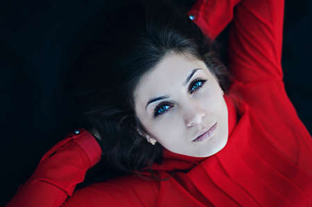 Portrait of exquisite beautiful young girl in a red blouse. Beautiful  portrait of a girl.の写真素材