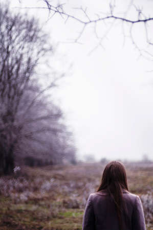 Portrait of a beautiful young girl outdoors. Outdoors portrait of beautiful young brunette woman looking at camera.の写真素材