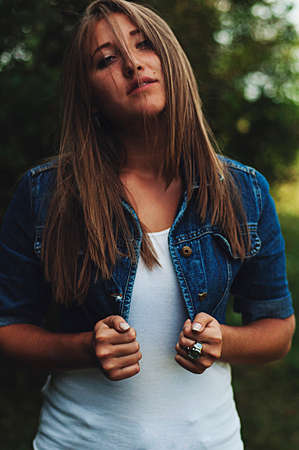 Portrait of a beautiful young girl outdoors. Outdoors portrait of beautiful young brunette woman looking at camera. Closeup sensual portrait of beautiful girl outdoors. Art photoの写真素材