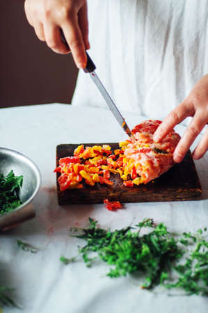 Vegetarians and cooking. Ladies hand cut green vegetable, ready to prepare healthy salad.の写真素材