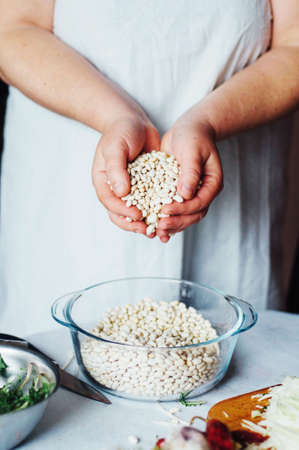 Vegetarians and cooking. Ladies hand cut green vegetable, ready to prepare healthy salad.の写真素材