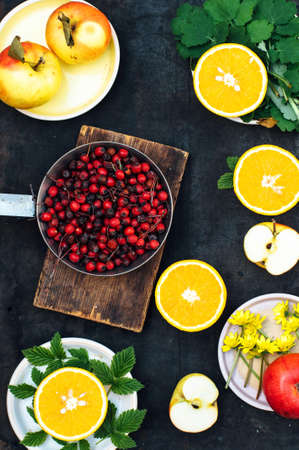 Mixed festive colorful tropical and citrus fruit sliced over black table top.の写真素材