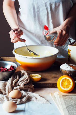 Steps of making cooking sandy cake with cherry filling : mixing ingredients: bowl, flour, eggs,  sour cream.の写真素材