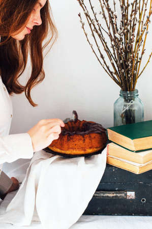 Summer Bundt Cake with Topped with Sugar Glaze, close up. Country kithen. Homemade cake with apples  and cinnamon. Delicious homemade  cake with nuts. Rustic style.の写真素材