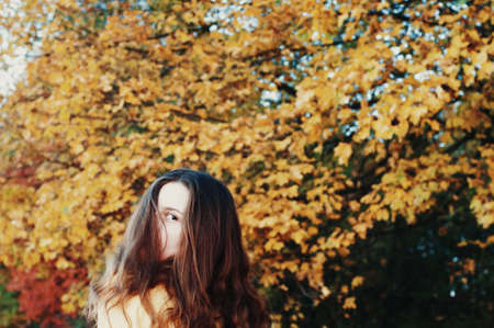 Freedom traveler woman. Image with instagram filter. Beautiful young woman  outdoor. Hiker young woman  in summer at sunset. in the forest among , trees  rear viewの写真素材