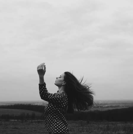 Freedom traveler woman. Beautiful young woman  outdoor. Hiker young woman  in summer at sunset. in the forest among , trees  rear viewの写真素材