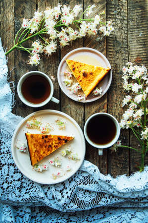Sweet casserole with cottage cheese and raisins on the table. Cheese casserole with raisins on plate on napkin on wooden table close-upの写真素材