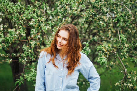 Stylish spring bohemian outfits. Wearing a white sweater and blaの写真素材