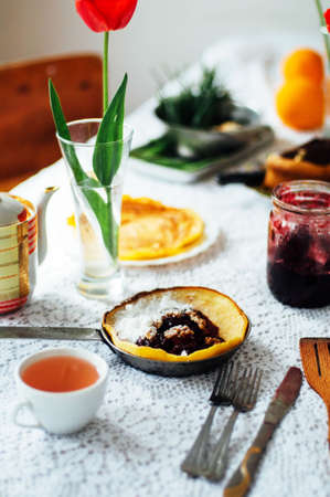 Stack of pancakes with red cherry jam. Pancakes withcherry jam. pancakes or fritters served with cherry jam, delicious dessert for breakfast , rustic style. Hot pancakes with cherry jam on pan.の写真素材
