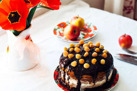 Piece of cake with Chocolate Glaze and raspberries on plate on white background. Beautiful...