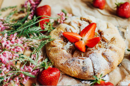 strawberry tart, strawberry shortcake, strawberry jam. serving homemade strawberry cake or pie on wooden rustic table. Strawberry tart on wooden tray, on rustic wooden backgroundの写真素材