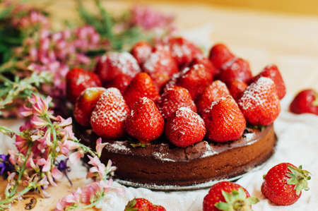strawberry tart, strawberry shortcake, strawberry jam. serving homemade strawberry cake or pie on wooden rustic table. Strawberry tart on wooden tray, on rustic wooden backgroundの写真素材